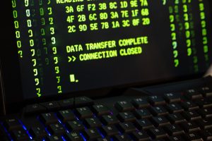 Data transfer complete message displayed on a computer monitor with a keyboard underneath