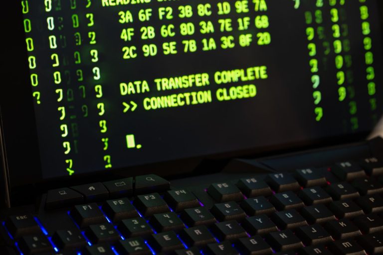 Data transfer complete message displayed on a computer monitor with a keyboard underneath