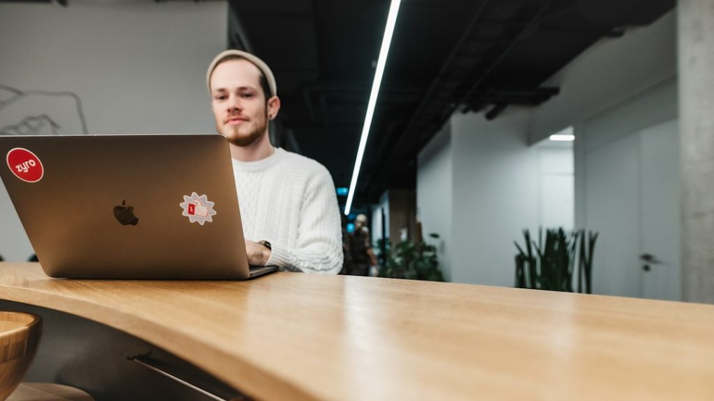 a man sitting in front of a laptop computer