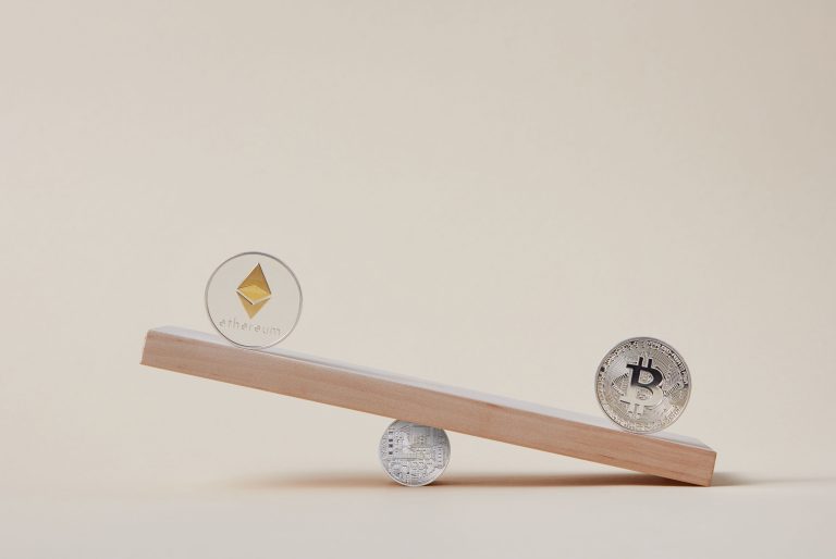 Minimalist image of Ethereum and Bitcoin coins balancing on a plank, symbolizing crypto market dynamics