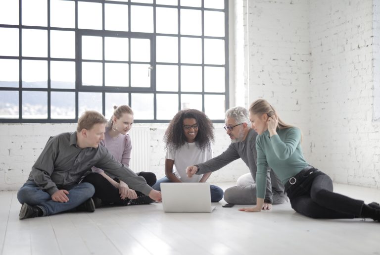 A multicultural team of professionals collaborating in a bright, modern office environment