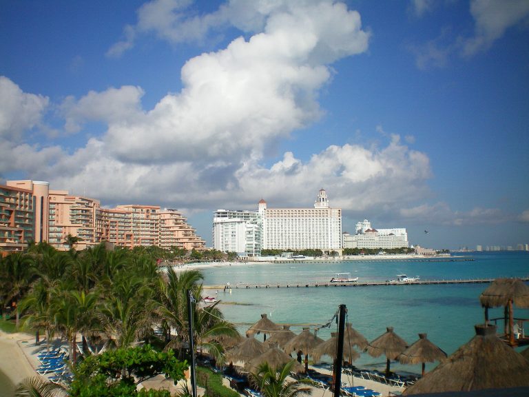 Breathtaking Cancún beachfront showcasing tropical resorts, turquoise waters, and blue skies