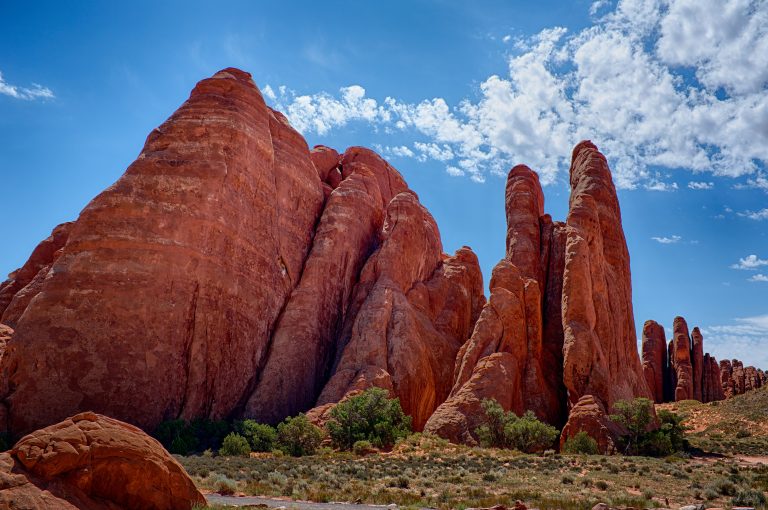 Stunning red rock formations under a bright blue sky in Emery County, Utah