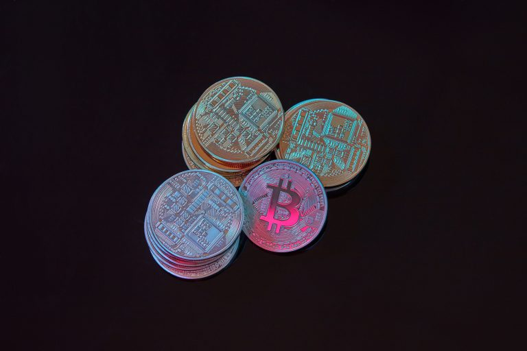 A detailed image showcasing a stack of Bitcoin cryptocurrency coins on a black background