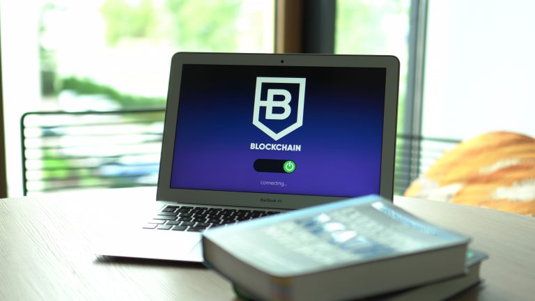 Laptop displaying blockchain connecting screen in modern setting