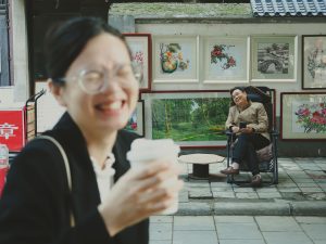 A vibrant street scene capturing people enjoying art and laughter outdoors
