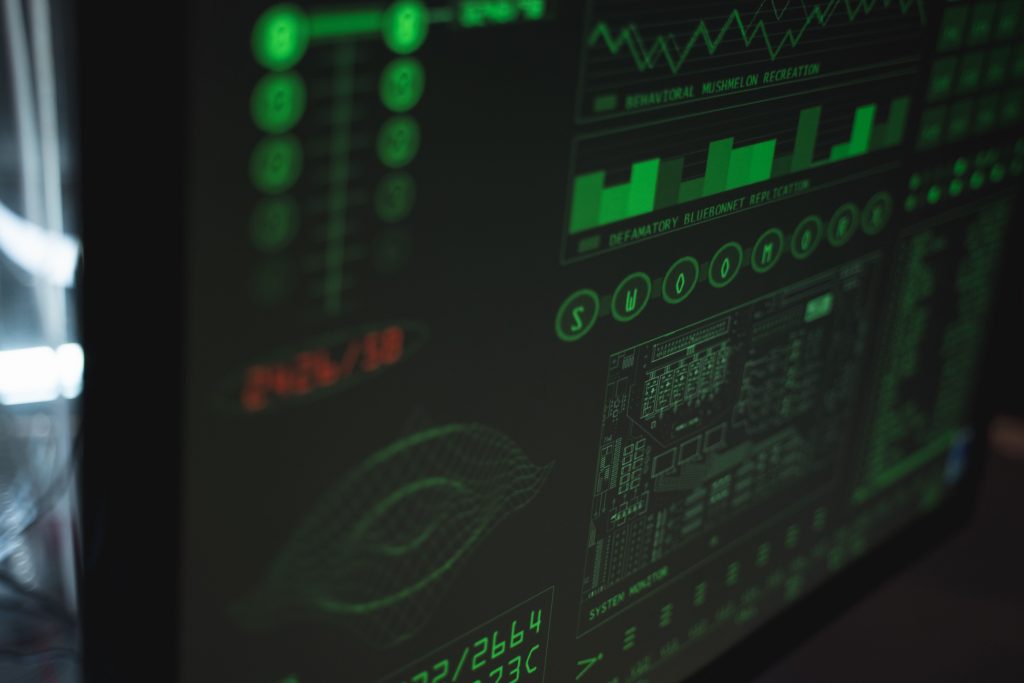 Close-up view of a computer displaying cybersecurity and data protection interfaces in green tones